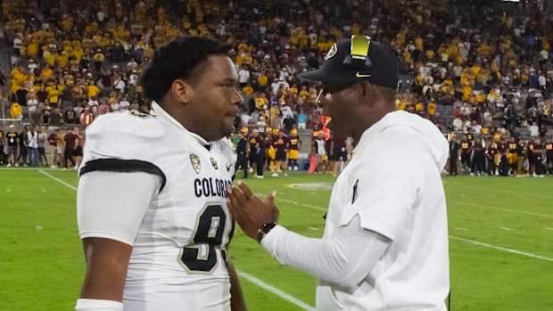 Oct 7, 2023; Tempe, Arizona, USA; Colorado Buffaloes head coach Deion Sanders talks to defensive lineman Bishop Thomas (95) against the Arizona State Sun Devils at Mountain America Stadium. Mandatory Credit: Mark J. Rebilas-USA TODAY Sports  